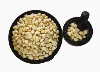 Freshly peeled garlic in the pottery & stone mortar isolated on white background. 