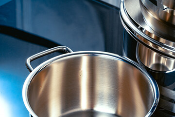 Set of aluminum pans on black surface close up