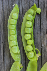 Young, green peas on a twig and on a Board close-up