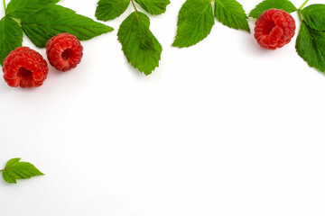 Three ripe raspberries with leaves isolated 