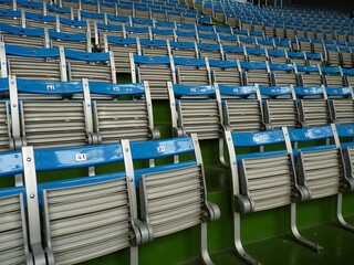 Fototapeta premium Empty stadium with blue plastic chairs and with nobody around