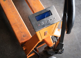 Obraz na płótnie Canvas Hand pallet truck or manual hand lift with check weigh digital scales.