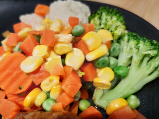 various colorful vegetables dressing corn carrot peas lemon serving on white plate serving with Sliced Grilled organic pork, beef Ribeye steak decorated, One famous menu of secret recipe from street f