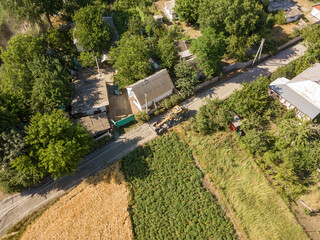 Aerial drone view. A grader on a rural street in Ukraine.