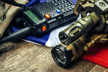 U.S. battle flag and assault rifle on the wooden table.