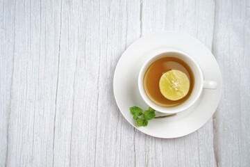 Top view of Cup of hot honey lemon tea and mint on wooden table. the concept of natural medicine.