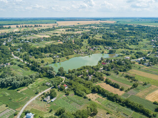 Aerial drone view. Green lake in the Ukrainian village.