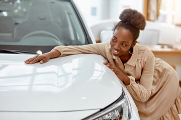 portrait of young africanamerican woman hugging new auto in cars showroom - obrazy, fototapety, plakaty