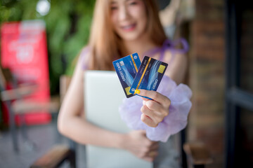 Beautiful woman showing two credit cards