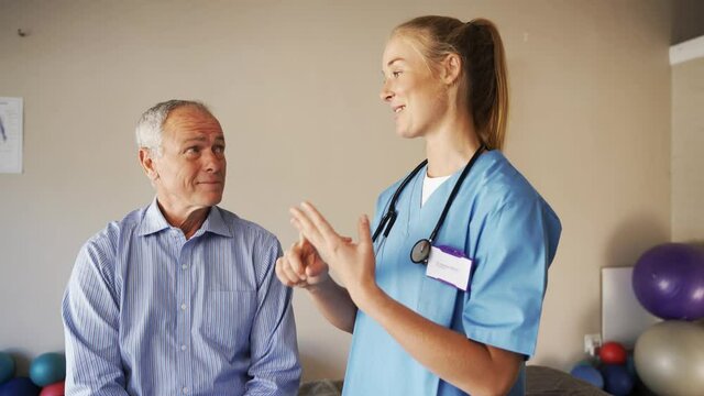 Female doctor discussing steps to recovery with elderly male patient