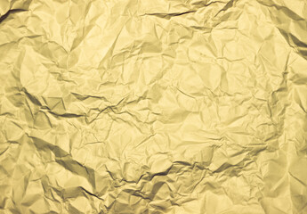 Crumpled gold background. Wrinkled gold texture.
