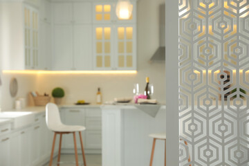 Blurred view of modern kitchen interior with stylish furniture, focus on partition