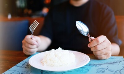 Man eating rice enjoying a meal in restaurant. man having dinner.