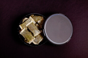 Box of Swedish nicotine, Swedish snus, chewing tobacco on a black background