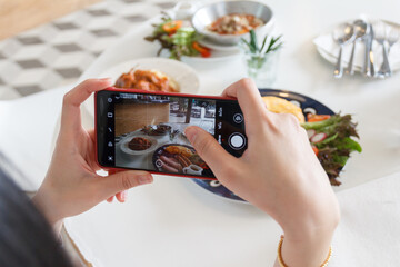 July 12 ,2020 - KhaoYai Thailand : Hands with the phone close-up pictures of the breakfast.