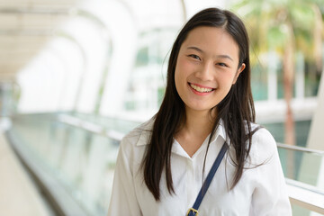 Young beautiful Asian businesswoman at the footbridge
