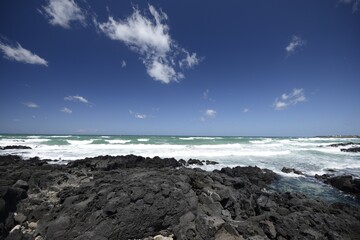 Beautiful shot of the coast on a cloudy blue sky background in Jeju Island, South Korea