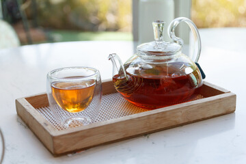 green tea in small cup and the kettle.