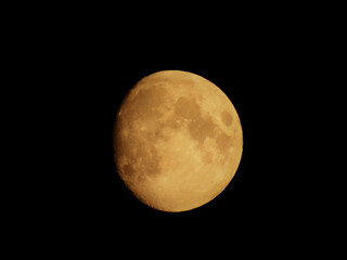 Liguria, Italy - 07/22/2020: Beautiful photography of the moonlight in the different phases with different colours. Black sky and little stars in the background.