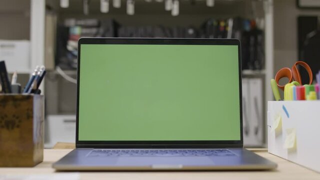 Designer home office. Green screen laptop computer sitting on a designer workspace. Footage shot with RED, available in 4K and HD. Download the preview for free.
