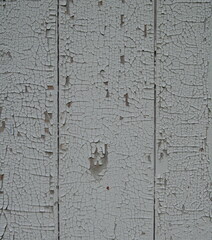 white peeling paint on a wooden wall