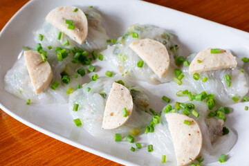 Bánh cuốn, Vietnamese steamed rice – skin dumpling topping with Asian pork sausage. serving on white plate