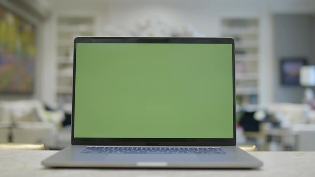 Home office. Green screen laptop computer sitting on a kitchen island. Footage shot with RED, available in 4K and HD. Download the preview for free.

