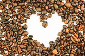 brown heart shaped texture background from roasted coffee beans can be used as template for design.