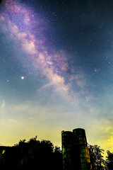 milky way on the sky with water tank in dark night
