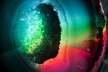 Iridescent natural transparent glossy geode and magic geometric Agate crystal stucture through sun light.