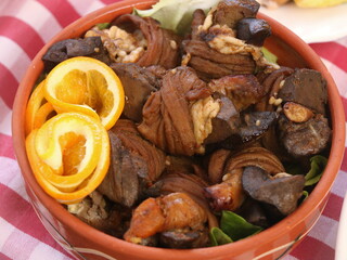 Rolled liver in an earthenware dish