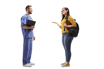 Full length profile shot of a male healthcare worker talking with a female student