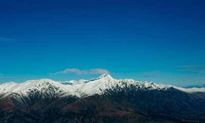 Winter landscape of snow mountain against blue sky in South island, New Zealand.