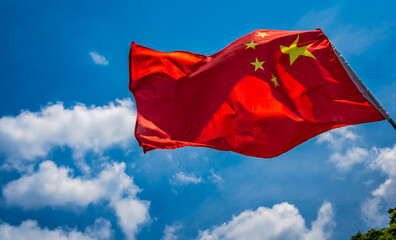 Fototapeta na wymiar Red Chinese national flag with blue sky background