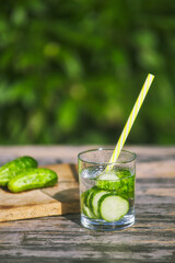 prepared summer cucumber cocktail. natural drinking useful water in nature. summer concept