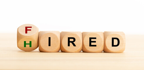Fired Hired concept. Wooden blocks with text on table. Employment or business concept. Copy space