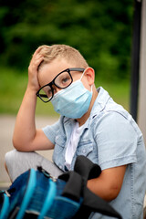 Portrait of a school boy wearing a face mask to avoid the spread of virus