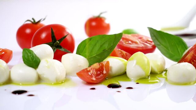 Tomato Mozzarella with Olive Oil isolated on white Background