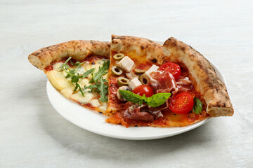 Slices of different delicious pizzas on light grey table