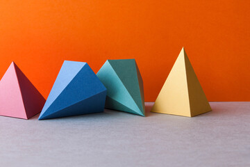 Colorful geometric abstract still life composition. Bright prism pyramid triangle shape figures....