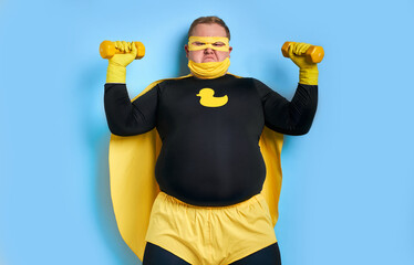fat funny superhero will defeat everyone, man shows his power and strength, his muscles can be...