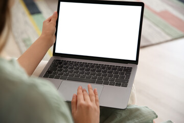 Woman using laptop at home, closeup. Space for design
