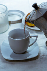  still life con taza de cafe con medialuna y jarra con leche sobre mantel blanco