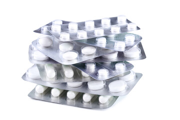 White pills in blisters on white background
