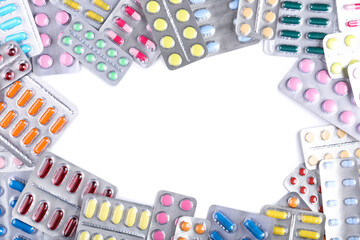Colorful pills in blisters on white background