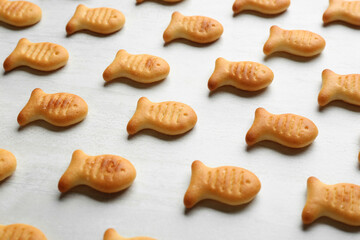 Delicious goldfish crackers on white table, closeup