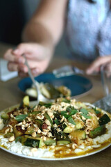 Ricotta cheese with rossted vegetables and nuts, served on a table. Selective focus.