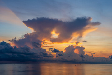 Naklejka na ściany i meble Sunrise on the island of Phu Quoc, Vietnam. Travel and nature concept. Morning sky, clouds, sun and sea water