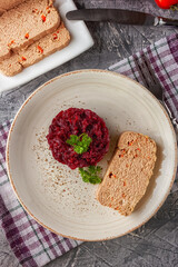 Fresh chicken terrine with beetroot confiture and parsley on a platter