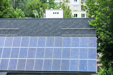 Building with installed solar panels on roof. Alternative energy source